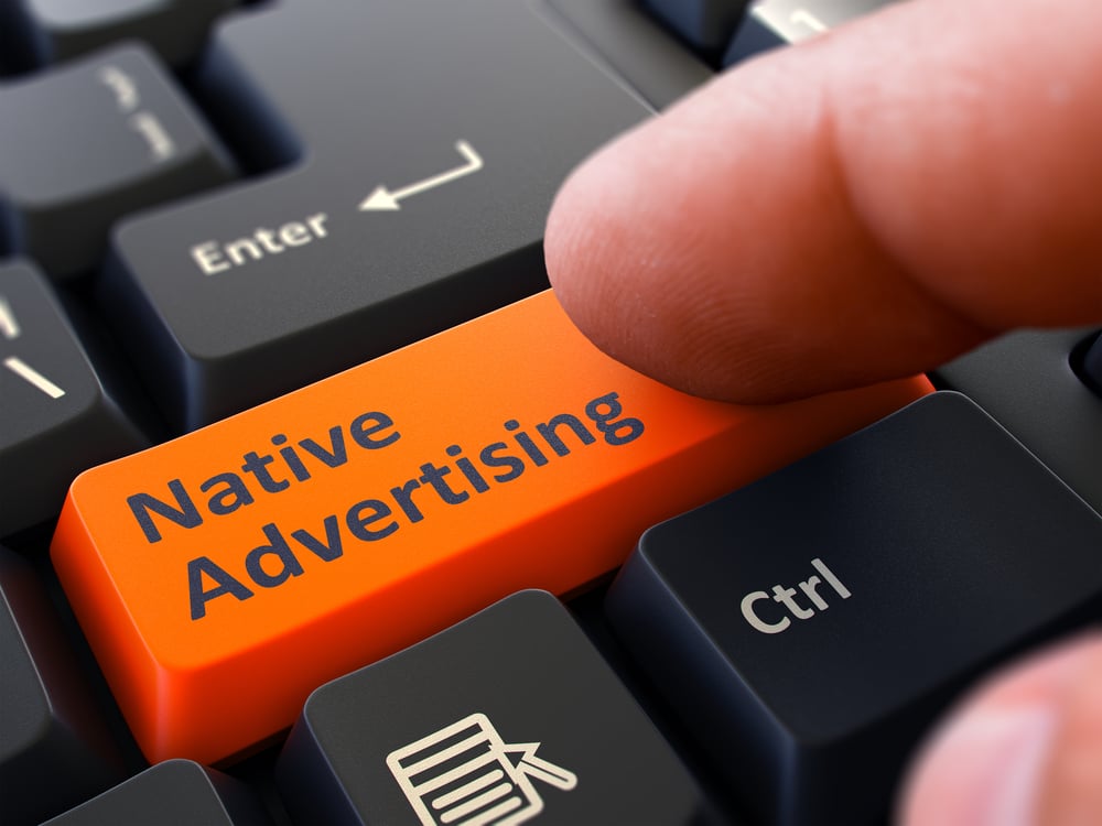 Native Advertising Button. Male Finger Clicks on Orange Button on Black Keyboard. Closeup View. Blurred Background.
